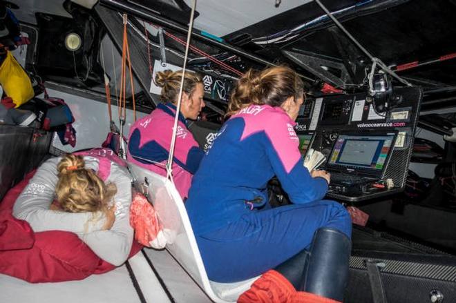 Onboard Team SCA. Annie Lush resting her sore lower back. Carolijn Brouwer and Libby Greenhalgh at the navigation station - Leg five to Itajai -  Volvo Ocean Race 2015 © Anna-Lena Elled/Team SCA